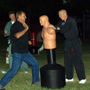Neighbors practicing palm heel strike on 
'Bubba' during a Neighborhood Watch get-together.